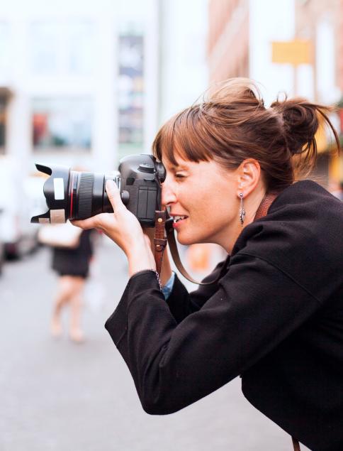 photojournalist takes a photo off frame